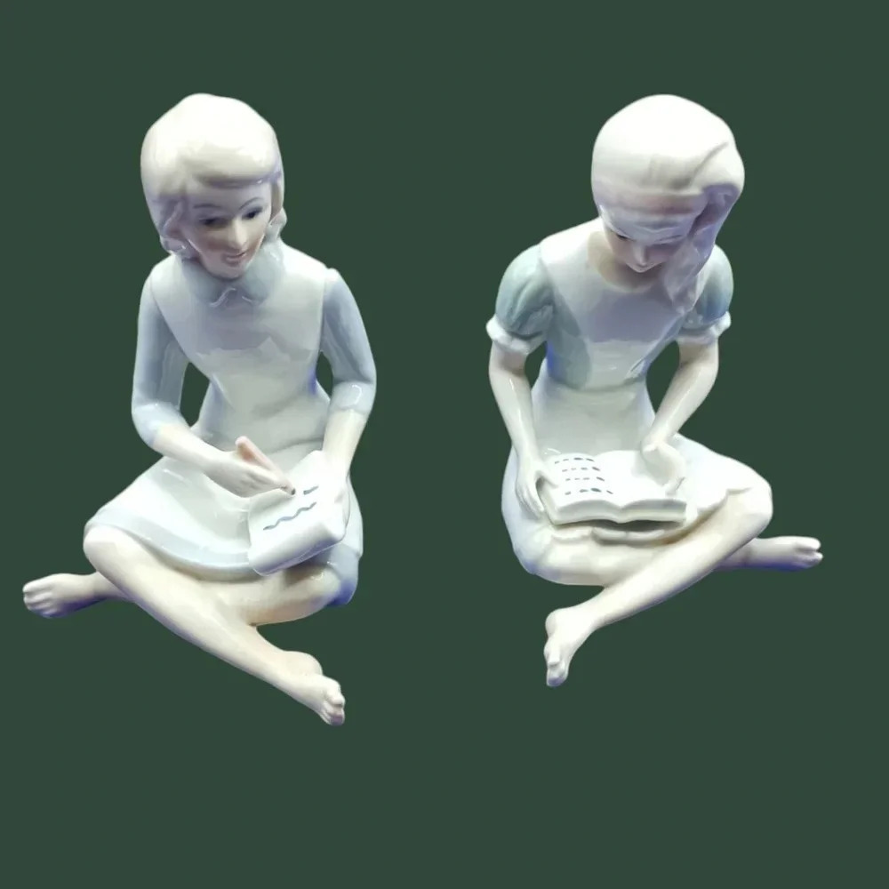 EW a set of 2 figures of girls, one reading and one writing